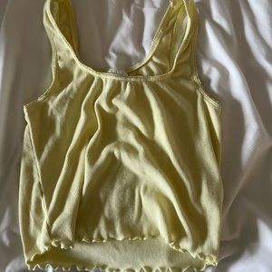 Pastel yellow ruffle and lace cropped tank top